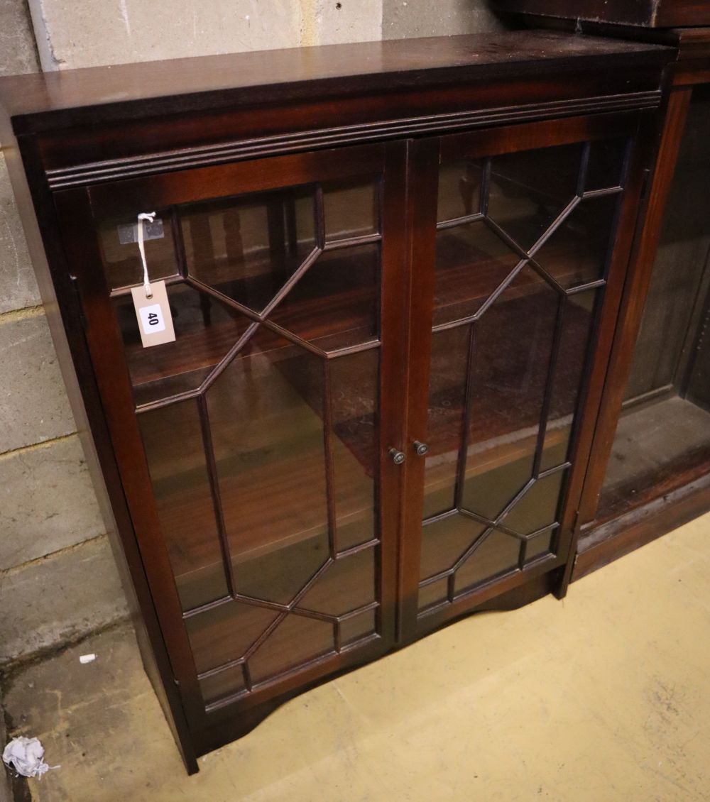 A reproduction mahogany bookcase, with astragal glazed doors, width 81cm, depth 25cm, height 102cm